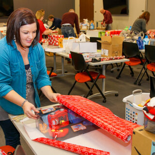 Ash Brokerage Impact Committee Wrap Presents for Christmas Families